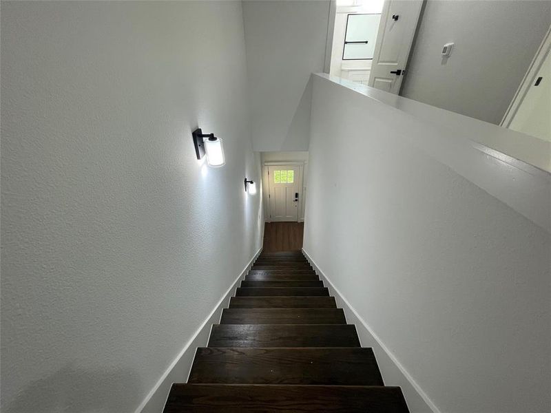 Stairway featuring wood finished floors and baseboards Stairway featuring wood finished floors and baseboards