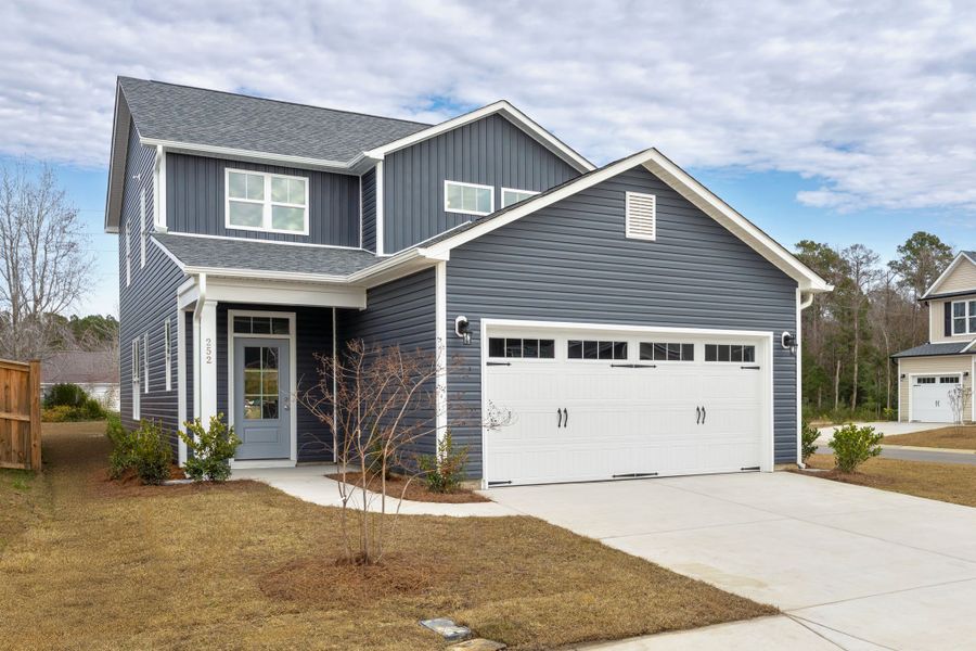 Front exterior of a new home in River Tide Farms, Bolivia, NC, highlighting curb appeal (Image 1). Front exterior of a new home in River Tide Farms, Bolivia, NC, highlighting curb appeal (Image 1).