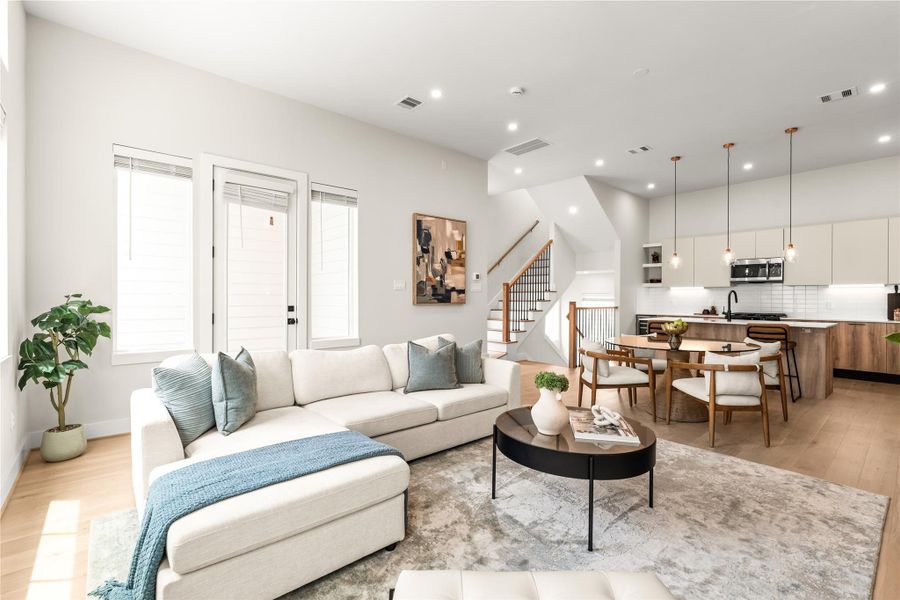 Windows on multiple sides brighten the living area, while the nearby exterior door leads you out to your covered balcony.