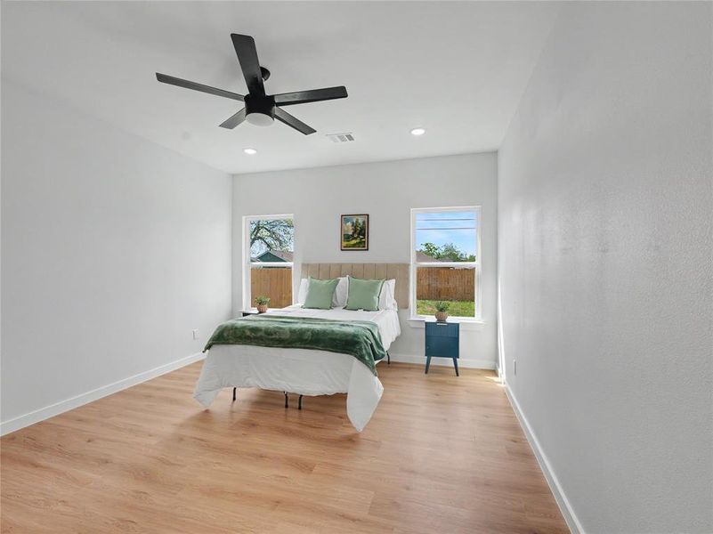 Bedroom featuring light wood-type flooring, ceiling fan, and recessed lighting