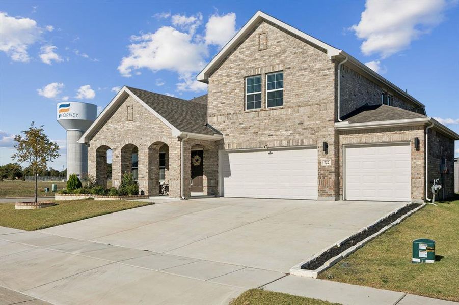 Front exterior of a new home in Prestige Collection at Overland Grove, Forney, TX, highlighting curb appeal (Image 2). Front exterior of a new home in Prestige Collection at Overland Grove, Forney, TX, highlighting curb appeal (Image 2).