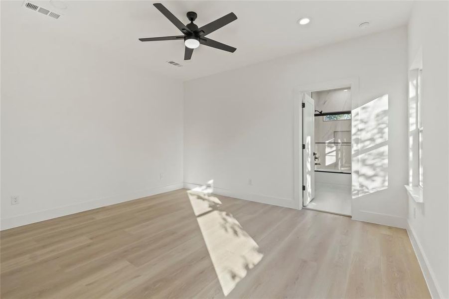 Spare room with light wood finished floors, a ceiling fan, and recessed lighting