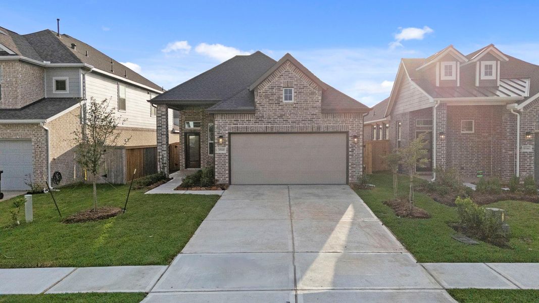 Front exterior of a new home in Emory Glen, Magnolia, TX, highlighting curb appeal (Image 19).