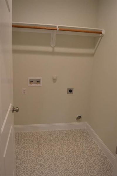 Full size laundry room with washer and dryer hook ups.