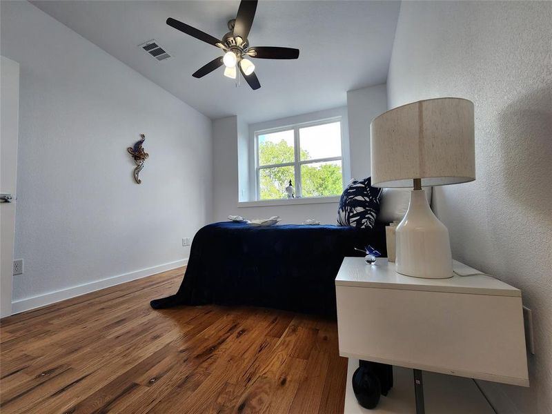 Bedroom featuring ceiling fan and dark hardwood / wood-style floors