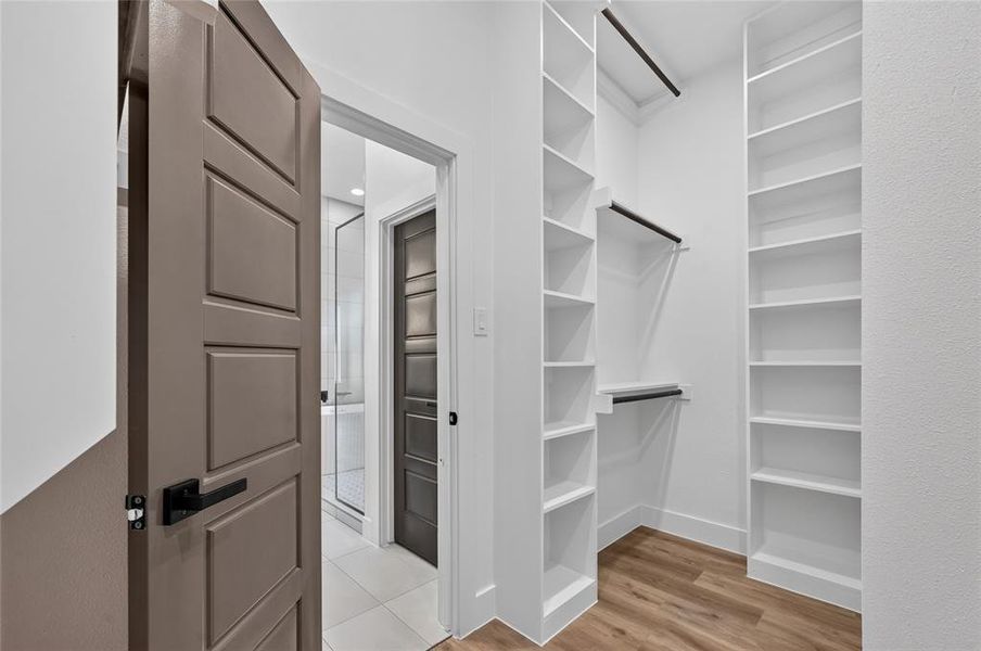 Custom closet system featuring extensive shelving and hanging rods Custom closet system featuring extensive shelving and hanging rods