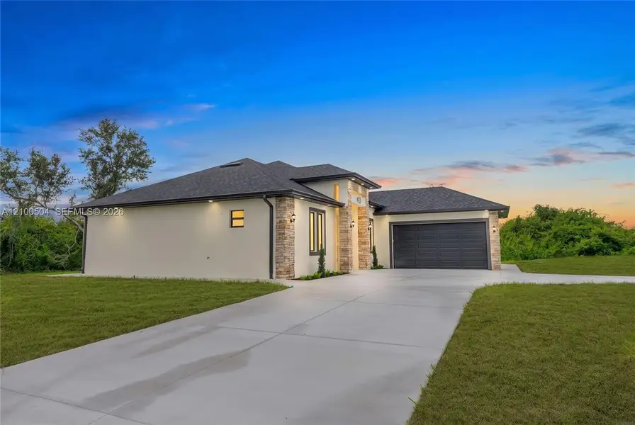 Front exterior of a new home in , Lehigh Acres, FL, highlighting curb appeal (Image 1). Front exterior of a new home in , Lehigh Acres, FL, highlighting curb appeal (Image 1).