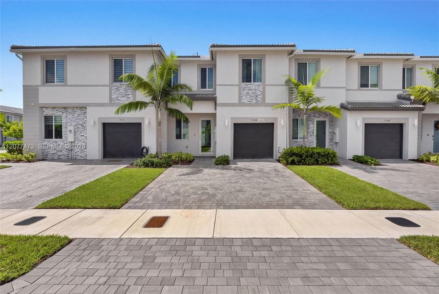 Front exterior of a new home in , Homestead, FL, highlighting curb appeal (Image 2). Front exterior of a new home in , Homestead, FL, highlighting curb appeal (Image 2).