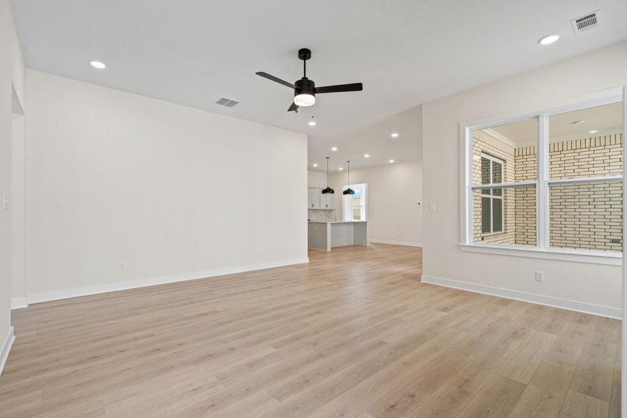 Unfurnished living room featuring recessed lighting, a ceiling fan, and light wood finished floors