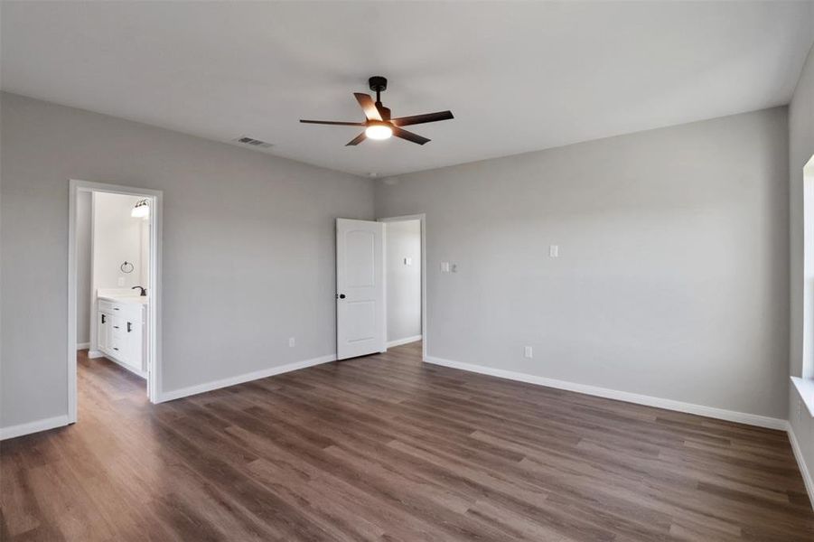 Spare room featuring dark hardwood / wood-style floors and ceiling fan