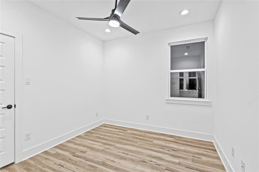 Spare room with light wood-type flooring and ceiling fan