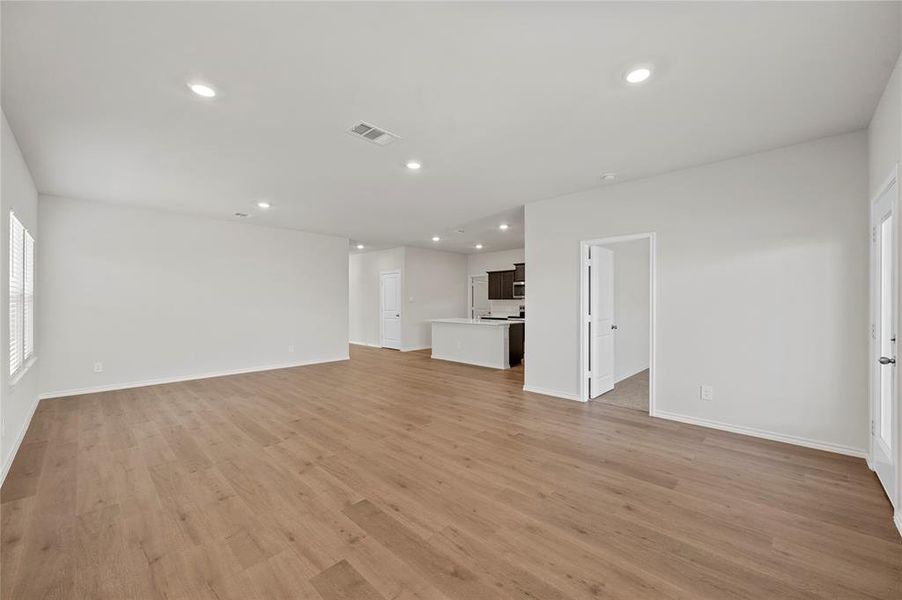 Unfurnished living room featuring light wood-style flooring and recessed lighting
