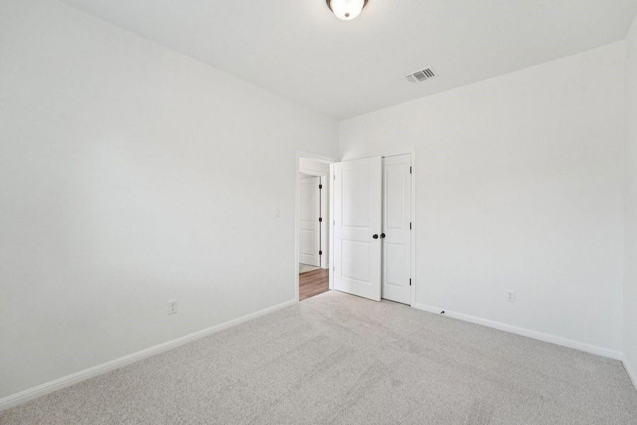 A spacious and neutral bedroom awaits customization, offering a blank canvas for personalization. A spacious and neutral bedroom awaits customization, offering a blank canvas for personalization.