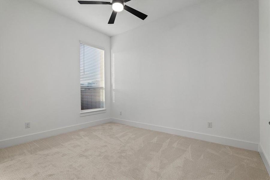 Spare room with light carpet and ceiling fan Spare room with light carpet and ceiling fan