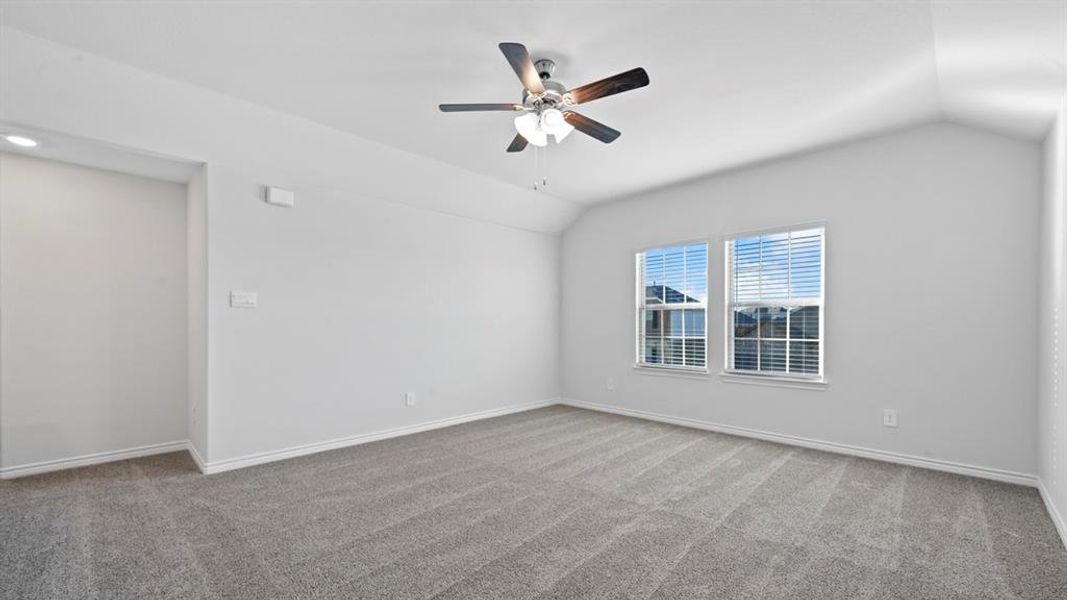 Unfurnished room with vaulted ceiling, light carpet, and ceiling fan Unfurnished room with vaulted ceiling, light carpet, and ceiling fan