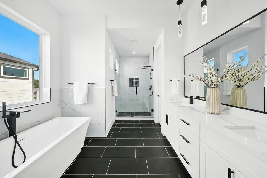 Spa-like primary bathroom with a modern, elegant design, featuring a freestanding soaking tub, frameless glass shower with designer tile, and dual vanities with Quartz countertops. High-end finishes, sleek black fixtures, and a spacious layout create a luxurious retreat perfect for relaxation and everyday comfort. Spa-like primary bathroom with a modern, elegant design, featuring a freestanding soaking tub, frameless glass shower with designer tile, and dual vanities with Quartz countertops. High-end finishes, sleek black fixtures, and a spacious layout create a luxurious retreat perfect for relaxation and everyday comfort.