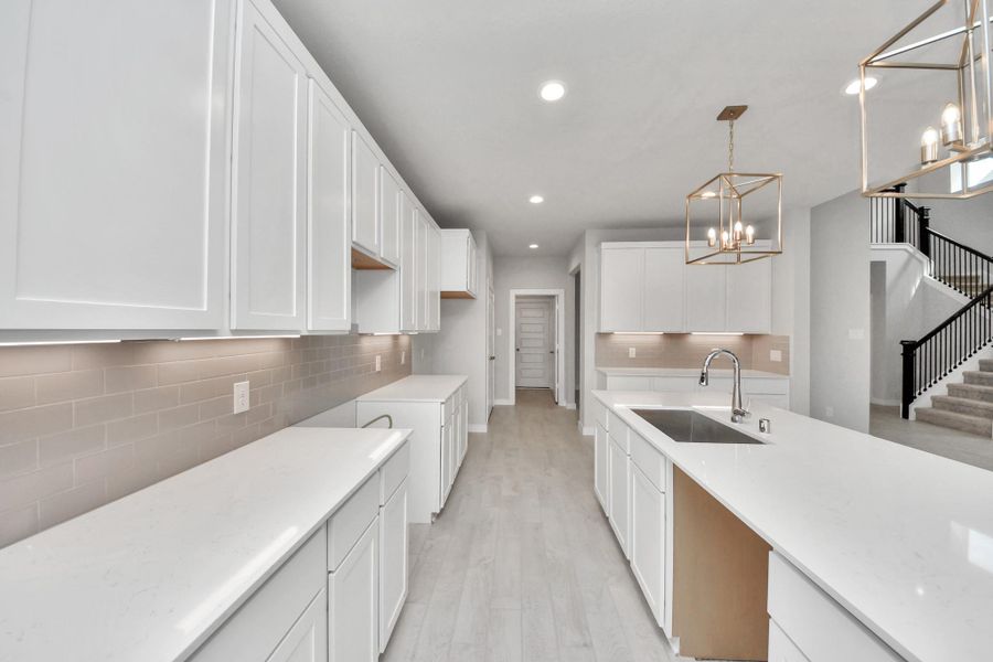 All of this overlooks your expansive family room, creating a perfect space for culinary delights and family gatherings. Sample photo of completed home with similar floor plan. Actual colors and selections may vary.