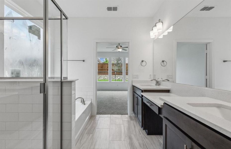 Owner's bath with oversized shower and dual vanity *real home pictured