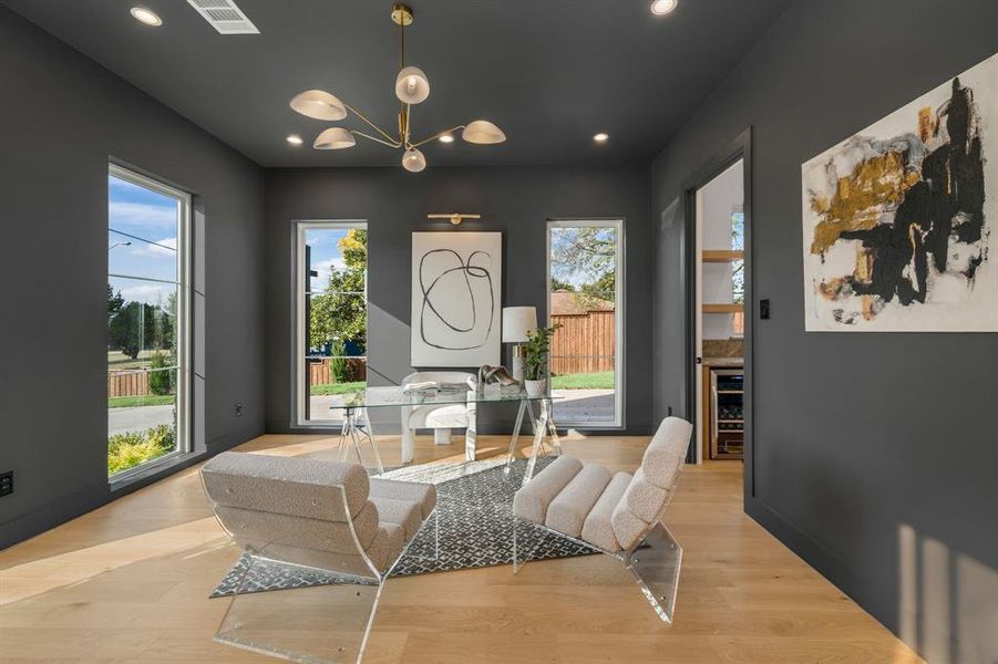 Sitting room with plenty of natural light, recessed lighting, beverage cooler, a chandelier, and light wood-style flooring