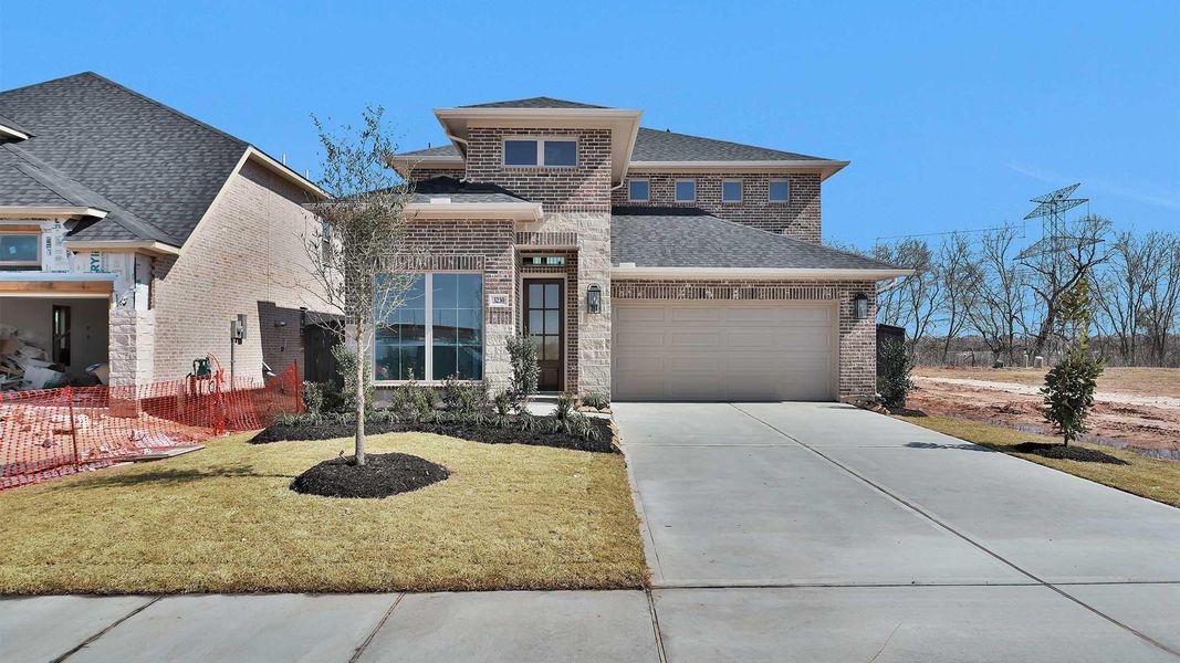 Front exterior of a new home in Harvest Green, Richmond, TX, highlighting curb appeal (Image 2).