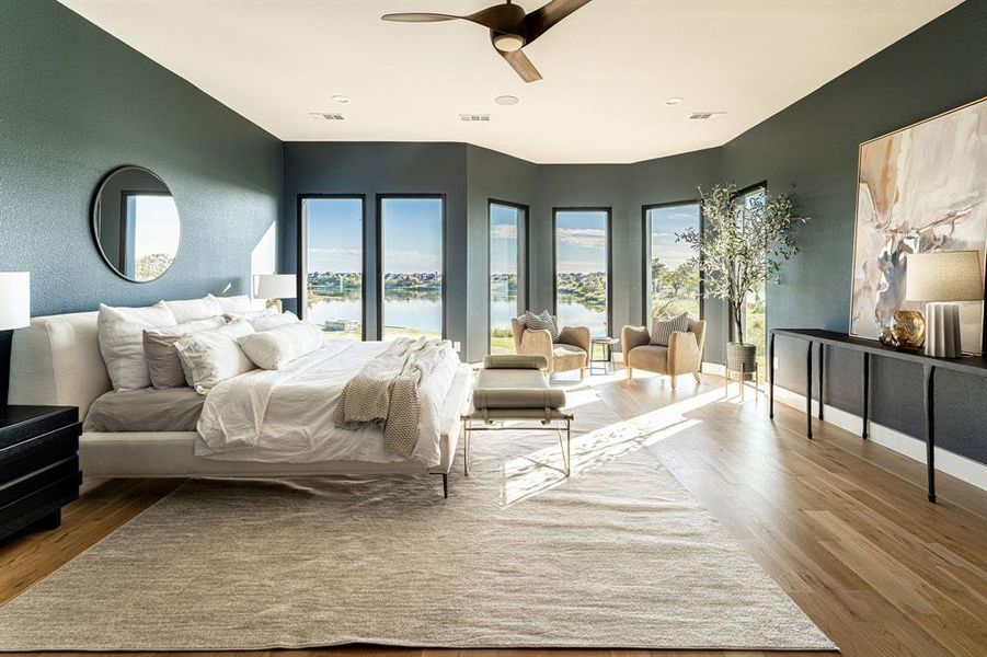 Bedroom with ceiling fan, a water view, and light hardwood / wood-style floors