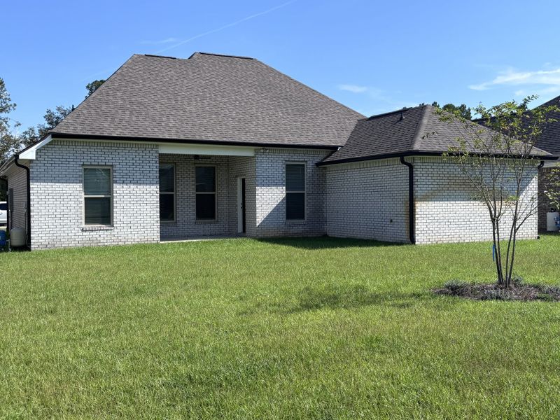 Exterior details and patio area of a home in Bird Song at Hammock Bay, Freeport (Image 19).