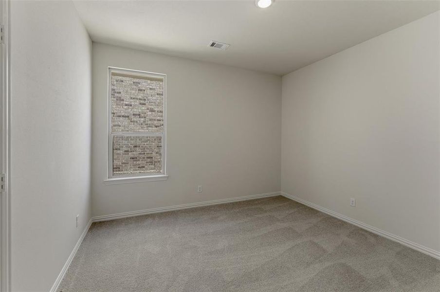 Neutral-toned walls and plush gray carpeting create a versatile interior space Neutral-toned walls and plush gray carpeting create a versatile interior space