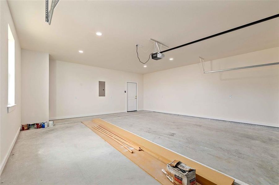 Garage with recessed lighting and electric panel Garage with recessed lighting and electric panel