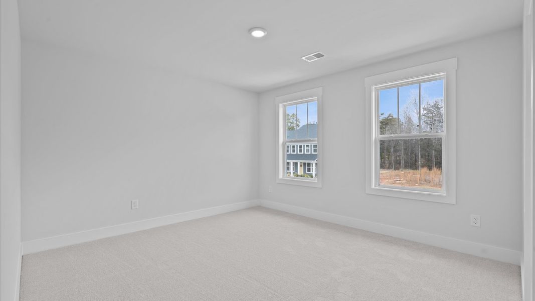 Accomplished design in this restful bedroom featuring plush carpet and oversized window views