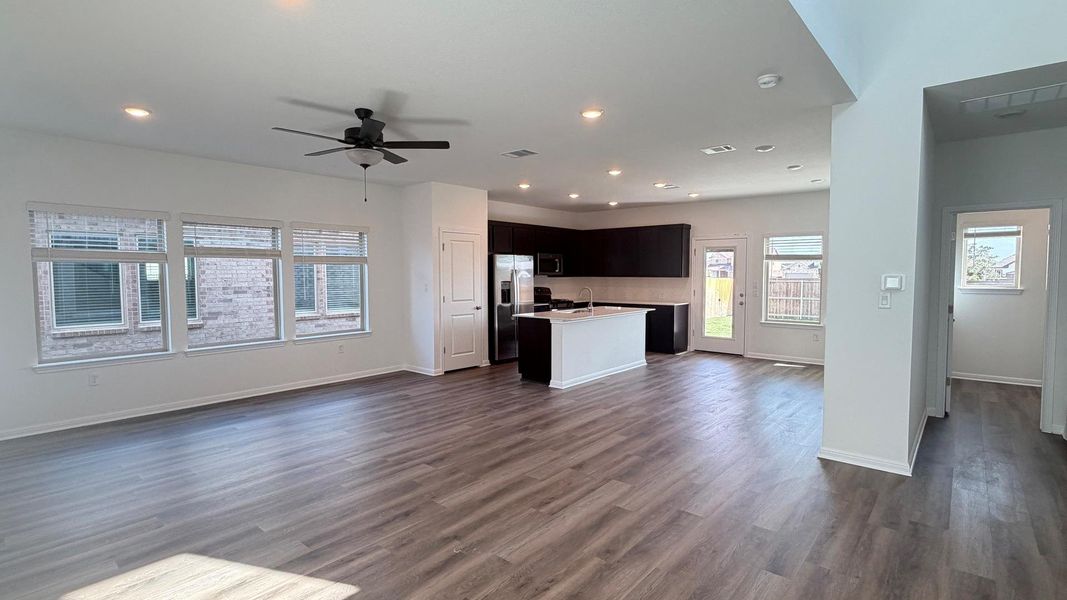An open-concept living area flows seamlessly into a well-appointed kitchen, ideal for modern living. An open-concept living area flows seamlessly into a well-appointed kitchen, ideal for modern living.