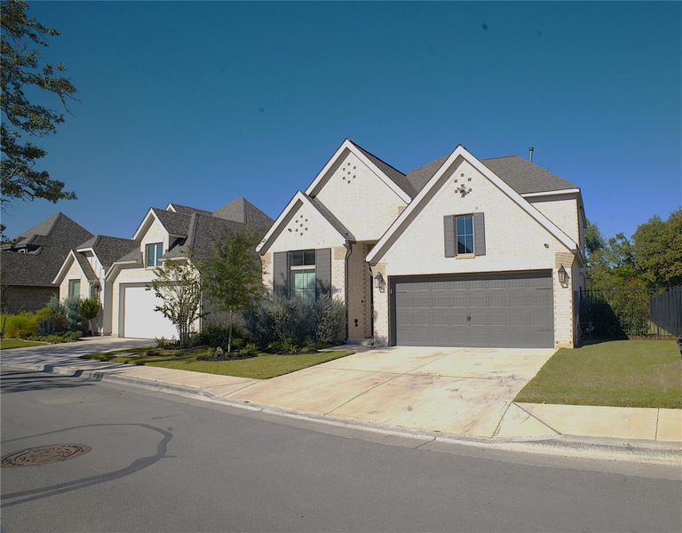 View of front of property with a garage, driveway, brick siding, and a front yard View of front of property with a garage, driveway, brick siding, and a front yard