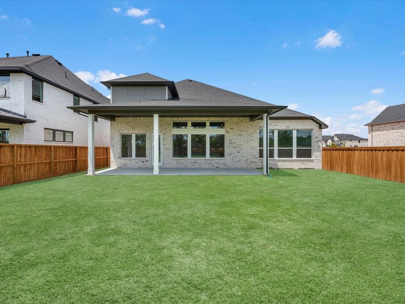 Exterior details and patio area of a home in Woodson’s Reserve, Spring (Image 3).