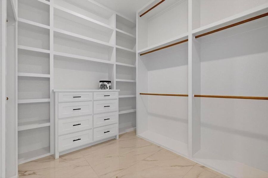 Spacious closet featuring light marble finish floors Spacious closet featuring light marble finish floors