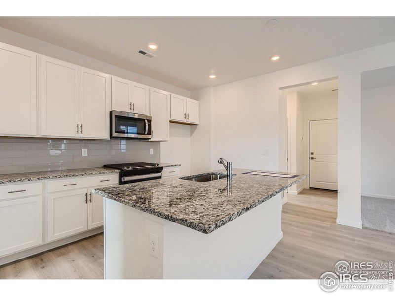 Big sized kitchen with gas stove.