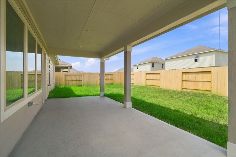 Extend your living space outdoors with this massive covered patio, perfect for year-round entertaining, rain or shine.