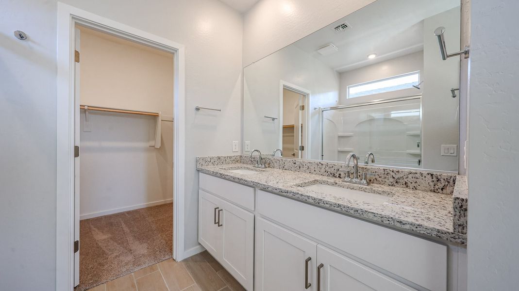 A bathroom with a large mirror. A bathroom with a large mirror.