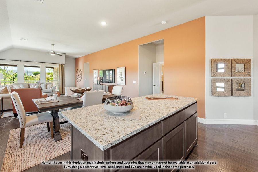 Open-concept kitchen with granite island, dark cabinets, and dining and living areas visible beyond Open-concept kitchen with granite island, dark cabinets, and dining and living areas visible beyond