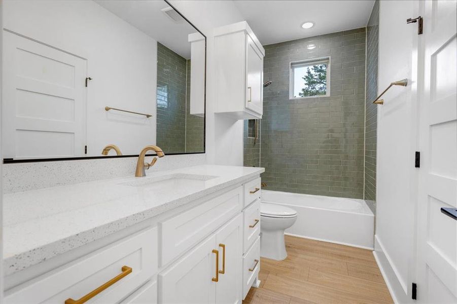 Full bathroom with vanity, light wood-style flooring, and  shower combination