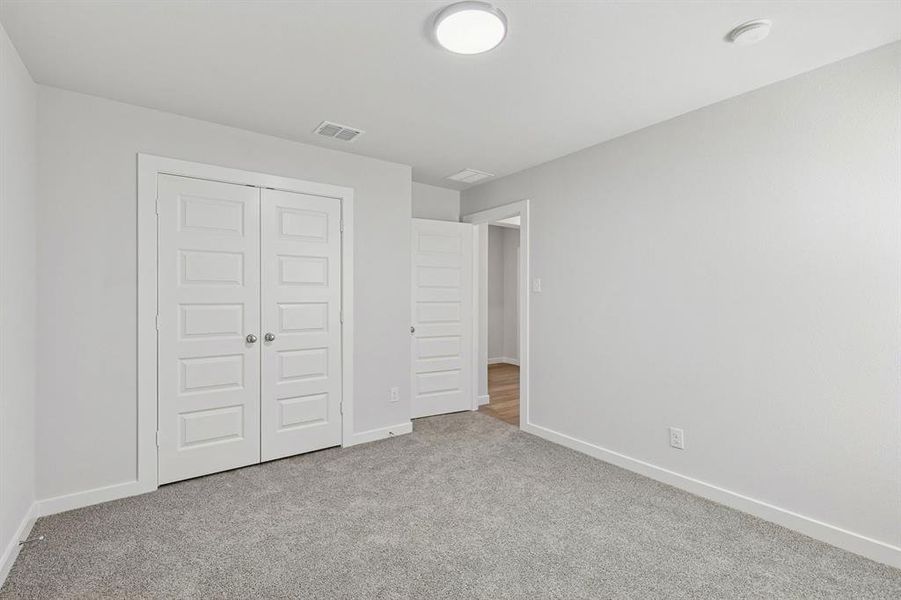 Bedroom in the Harrison home plan by Trophy Signature Homes – REPRESENTATIVE PHOTO