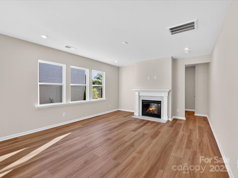 Great Room with Gas Fireplace and Bright Open Windows.