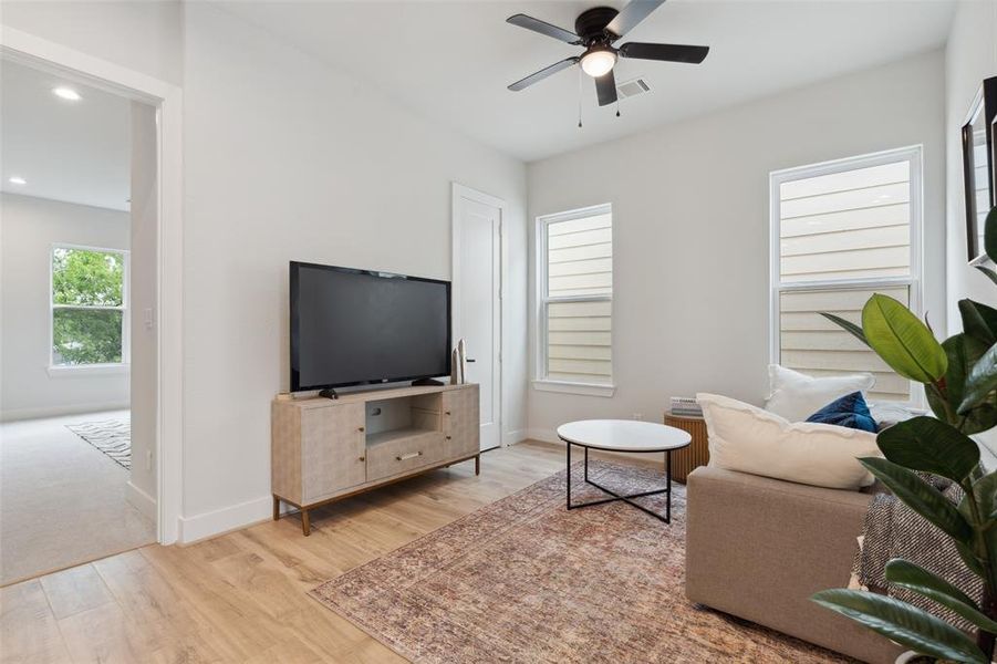 Another look at the secondary living space separating the primary bedroom from the secondary and third bedrooms.