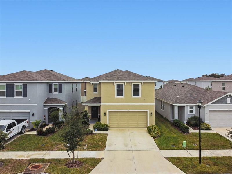 Front exterior of a new home in Westgate at Avalon Park, Wesley Chapel, FL, highlighting curb appeal (Image 33).