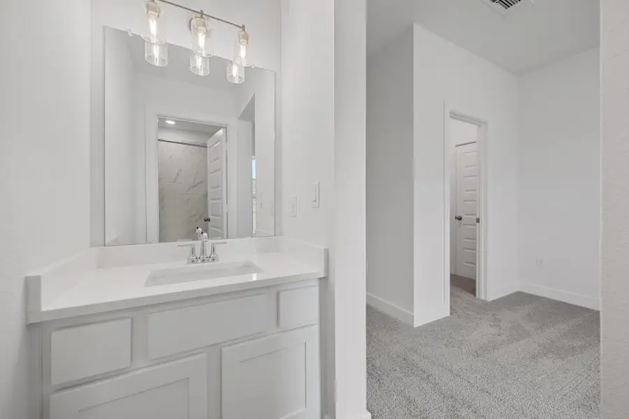 Bathroom featuring vanity and baseboards Bathroom featuring vanity and baseboards