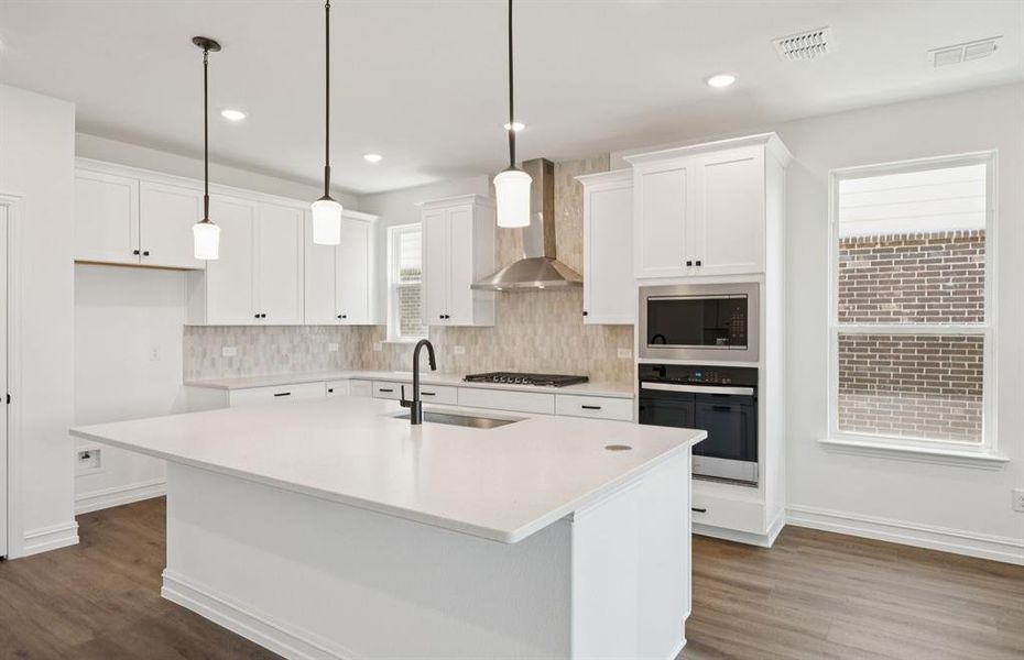 Bright kitchen with an expansive center island perfect for gatherings *Real home pictured Bright kitchen with an expansive center island perfect for gatherings *Real home pictured