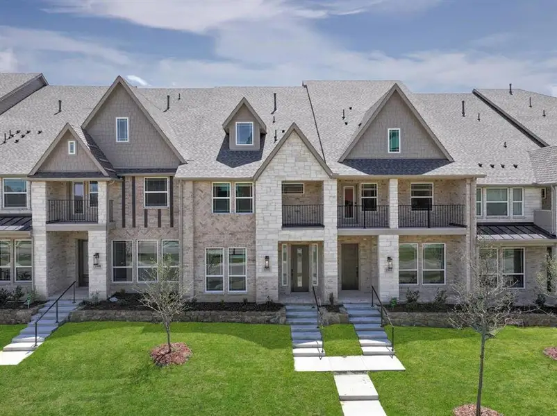 Front exterior of a new home in The Abbey at Mercer Crossing, Farmers Branch, TX, highlighting curb appeal (Image 1). Front exterior of a new home in The Abbey at Mercer Crossing, Farmers Branch, TX, highlighting curb appeal (Image 1).