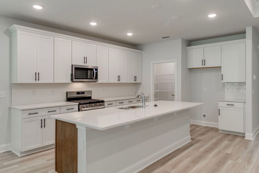 Beautiful open kitchen with bright, warm lighting and a large island.