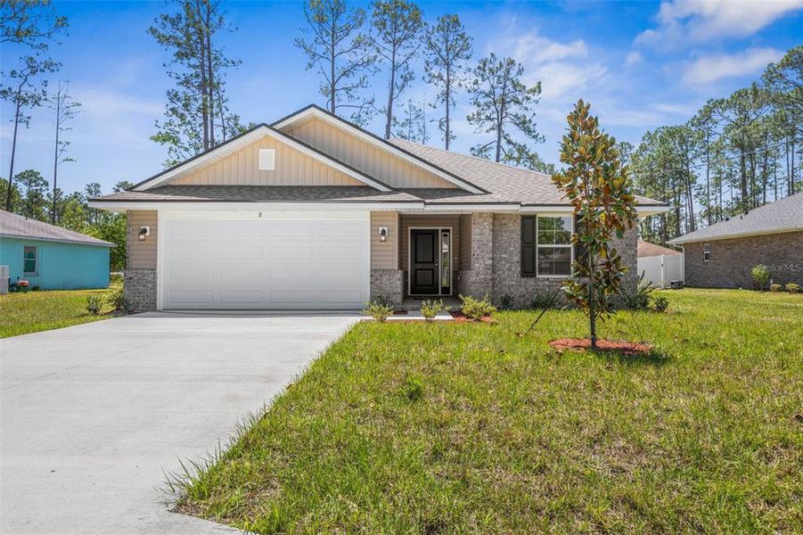Front exterior of a new home in Palm Coast, Palm Coast, FL, highlighting curb appeal (Image 1). Front exterior of a new home in Palm Coast, Palm Coast, FL, highlighting curb appeal (Image 1).