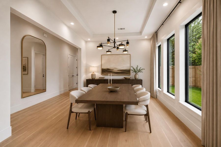 Natural light pours through oversized windows, highlighting soaring ceilings and creating an elegant backdrop for everyday dining and effortless entertaining. Positioned just off the main living spaces, the room offers a seamless flow while maintaining a refined sense of occasion. **Virtually staged**