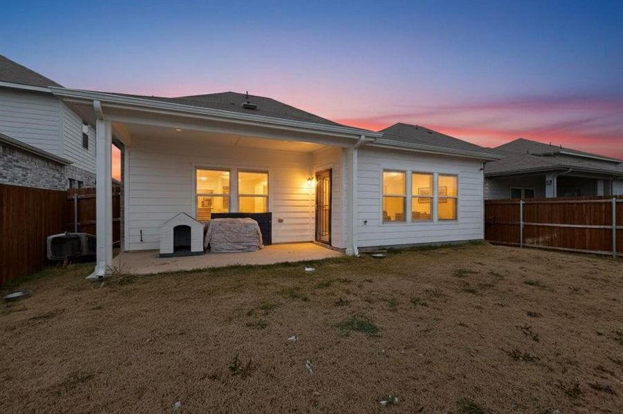Rear view of property featuring a fenced backyard and a patio Rear view of property featuring a fenced backyard and a patio