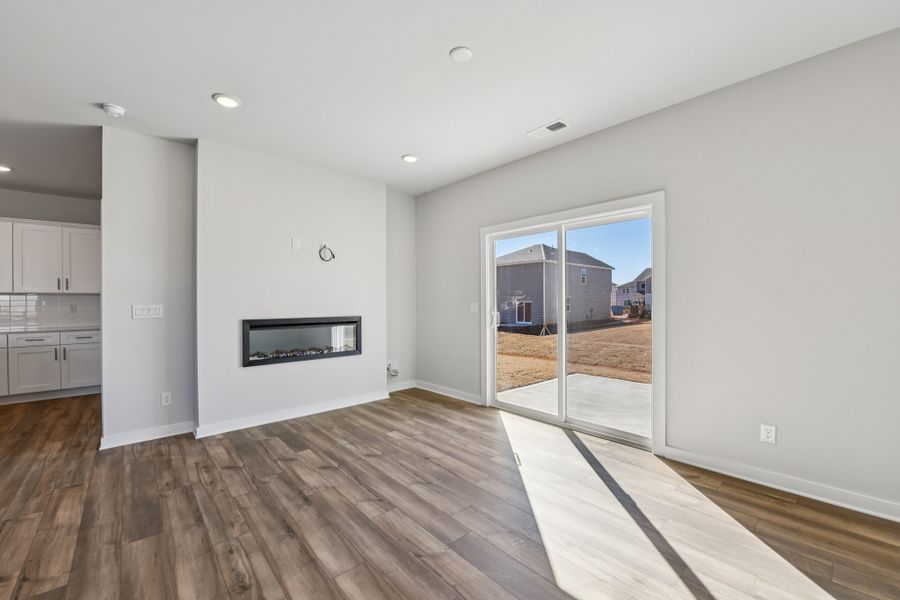 A room with a wood floor and white walls.